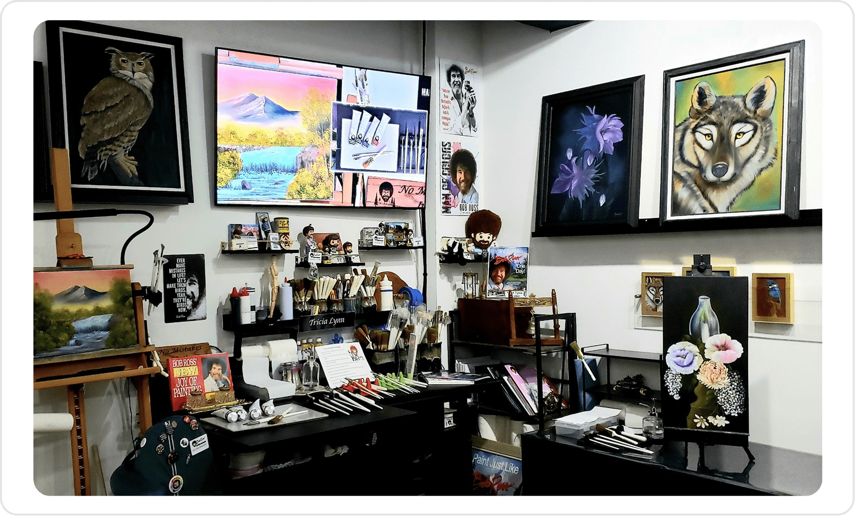 Art studio with paintings and art supplies.